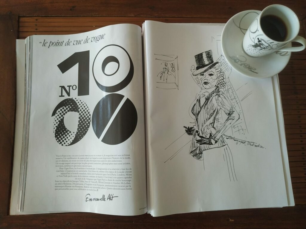 Magazine vogue ouvert sur un croquis de mode