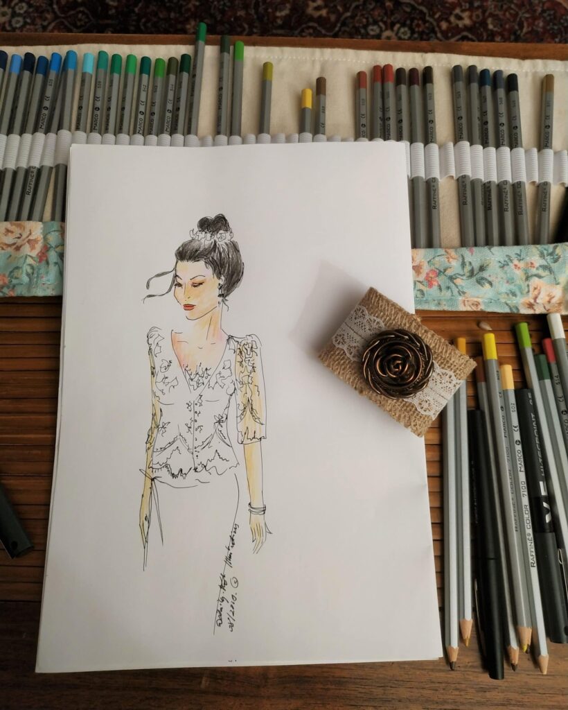 Dessin de marié en cours, posé sur toutes la boite de crayons de couleurs