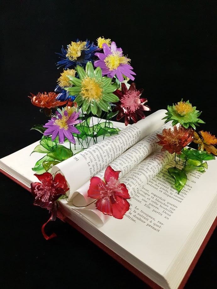Fleurs de l'artiste upcycling, Renaissance, piquées dans les pages du livre ouvert