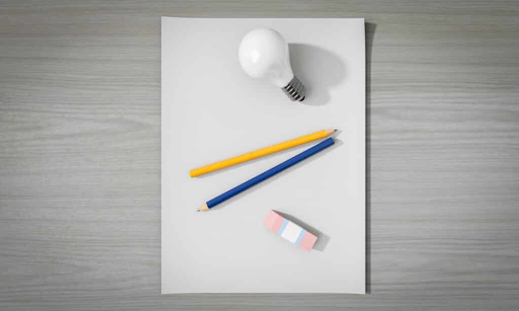 Page blanche d'un bloc note avec deux crayons papiers et une gomme